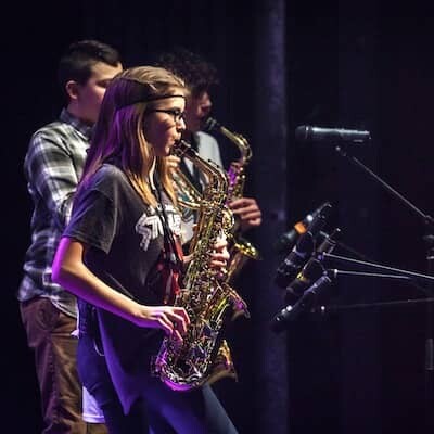 Students performing their saxophones in a Concert