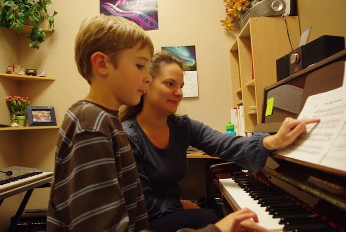 Young boy taking a Piano lesson with Lora Wentworth