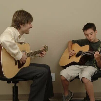 Noel Wentworth teaching guitar to a student at the Upbeat Music Academy Kelowna