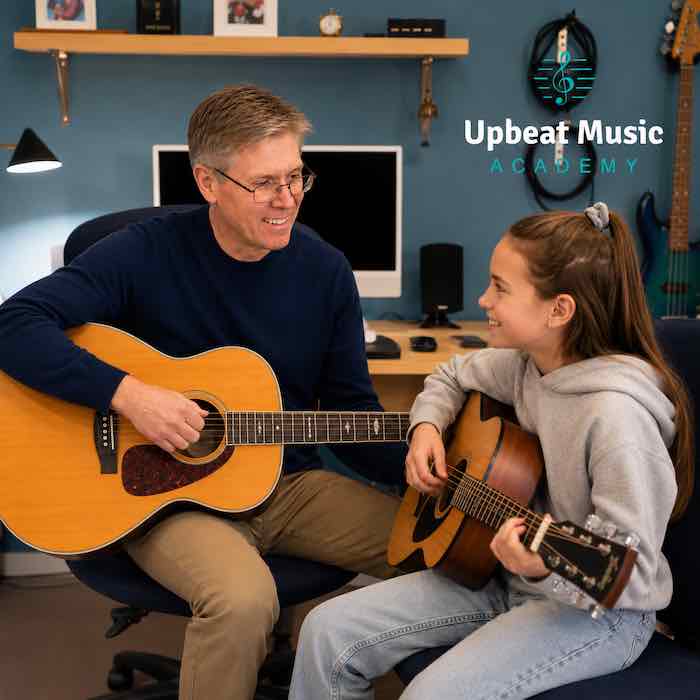 Beginner Guitar Lessons Kelowna Noel Wentworth teaching a young student how to play the Ukulele